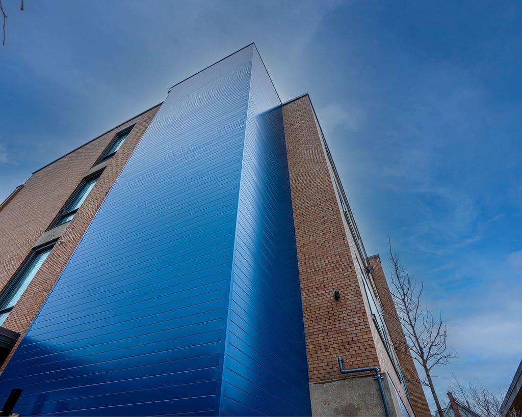Eccles-27 Commercial building with blue aluminum panels and brick walls