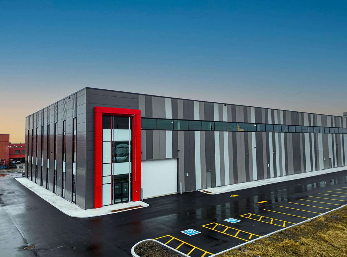25 Industrial facility with insulated panels and red ACM entrance