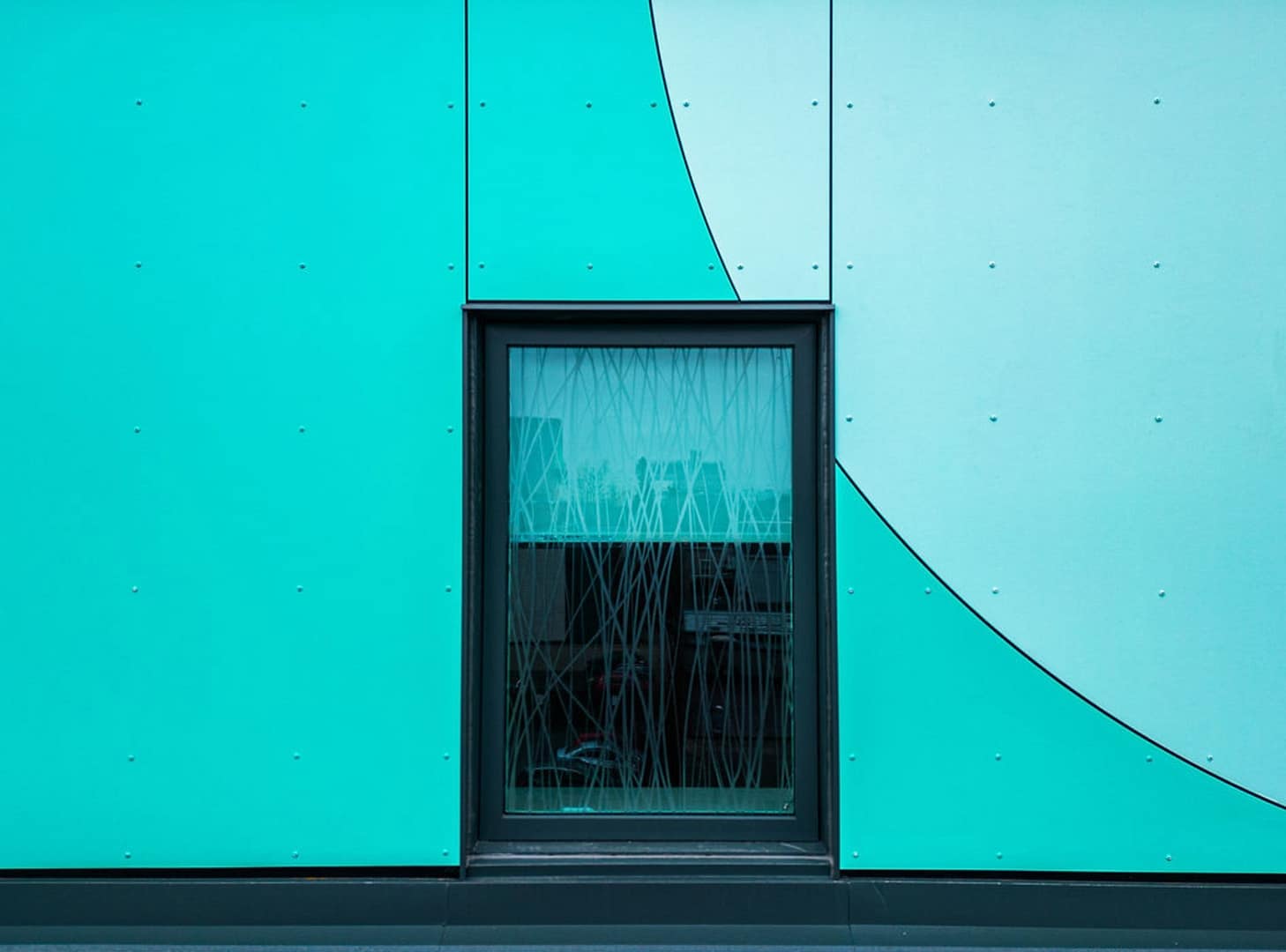 30 Close-up of window framed by turquoise ACM cladding
