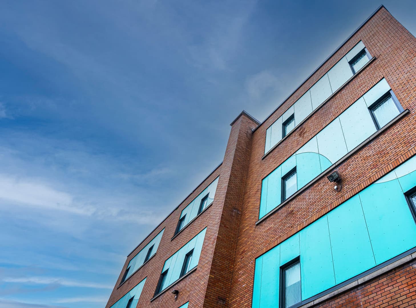 36 Brick structure featuring turquoise cladding panels on windows