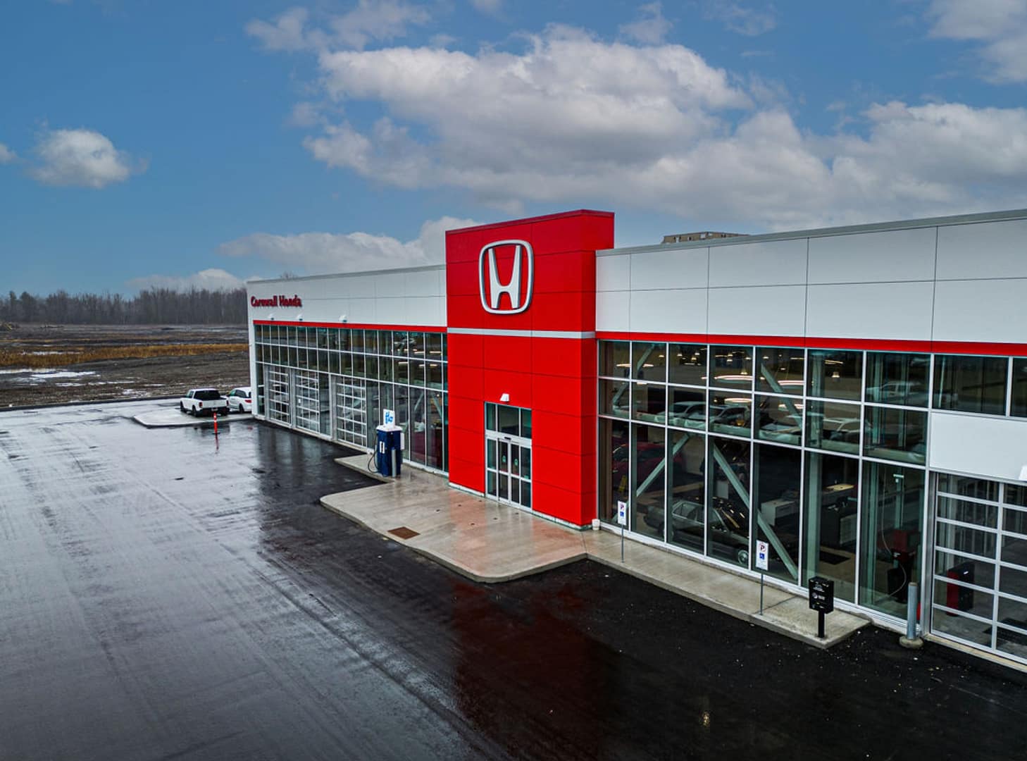 41 Honda dealership exterior with red ACM entrance and glass facade