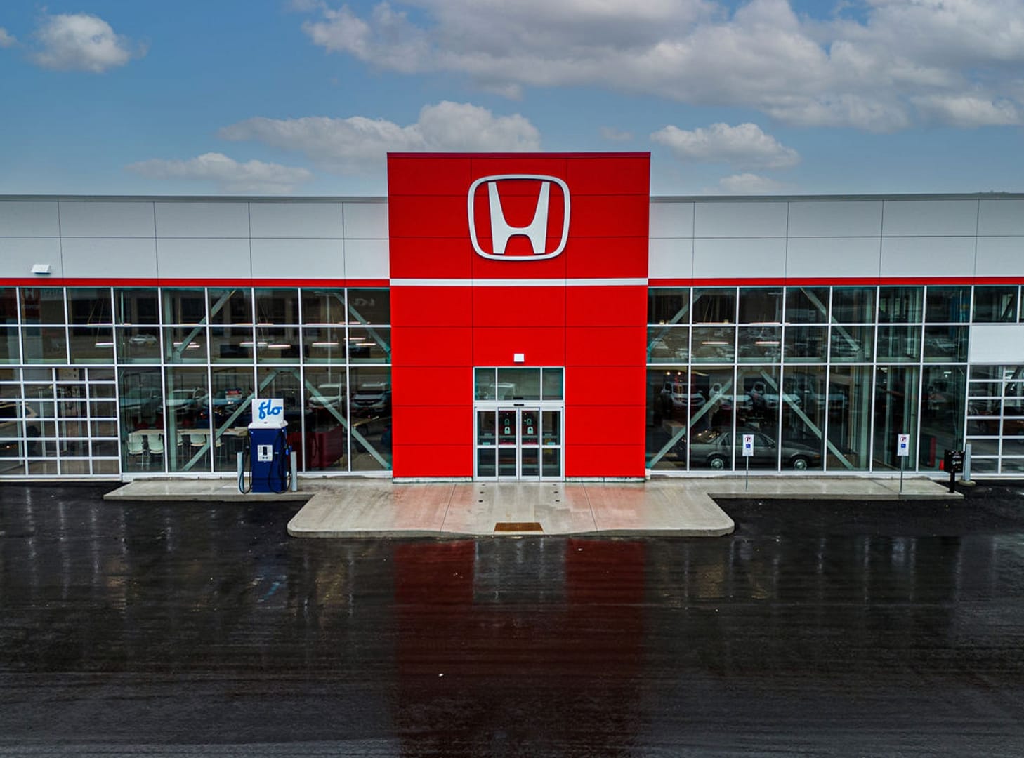 42 Front view of Honda dealership with red ACM entrance and glass